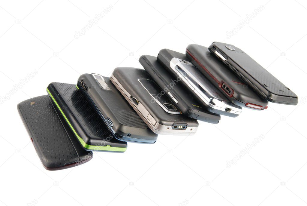 Row of modern mobile phones on white