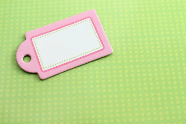 Etiqueta rosa en blanco sobre verde — Foto de Stock
