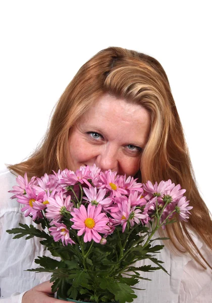 stock image Woman smelling flowers