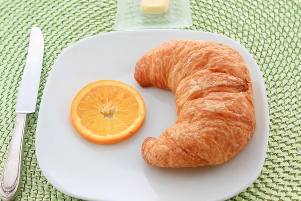 Golden croissant for breakfast — Stock Photo, Image