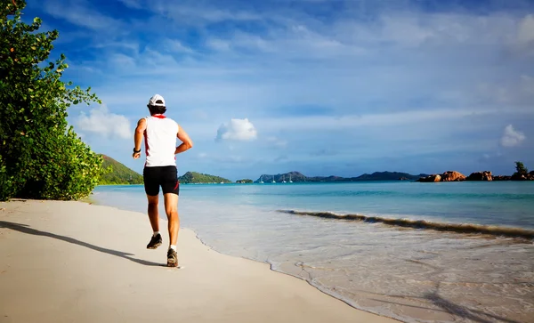 Man running on a tropical beach — Stock Photo, Image