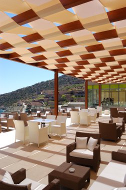 Chairs at sea view relaxation area of luxury hotel, Crete, Greec clipart