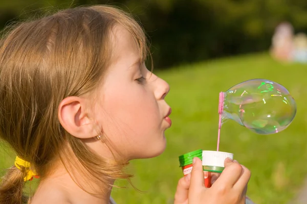 Girl and a soap bubble — Stock Photo, Image