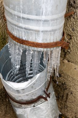 Icicles on a drainpipe clipart