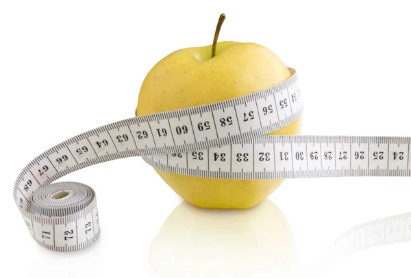 Яблоко и измеритель — стоковое фото