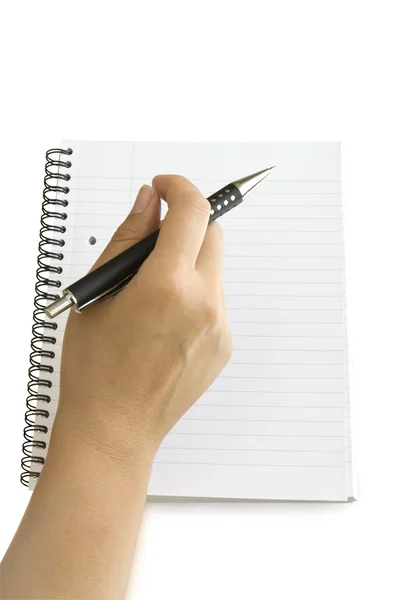 Mão com caneta no caderno — Fotografia de Stock