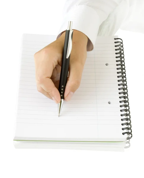 Hand med penna skriva på anteckningsboken Stockbild