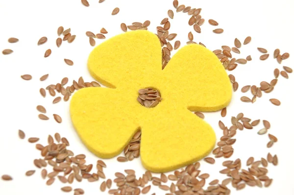 Flax seed and felt decoration — Stock Photo, Image
