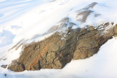 Snow-covered rock in the snow clipart