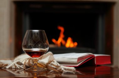 Cognac by the fireplace clipart