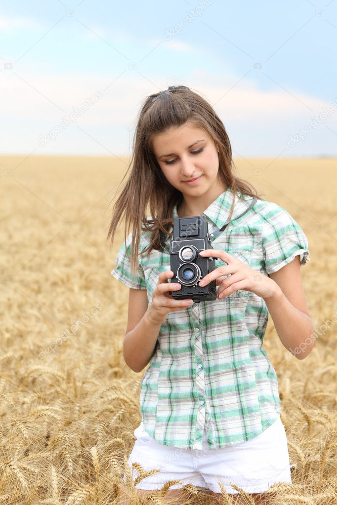 Young girl with vintage camera