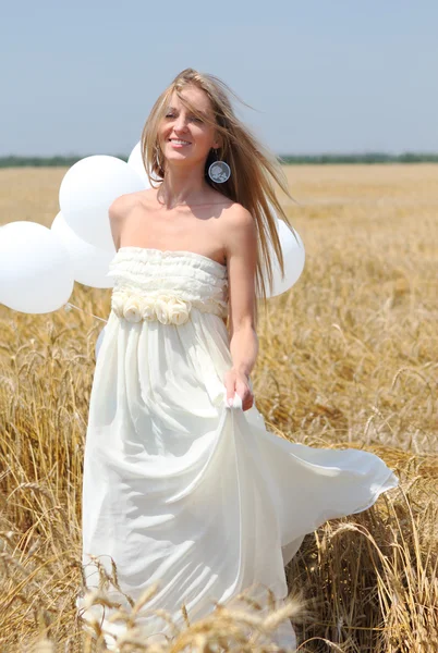 Smiling girl with white balloons — Stock Photo, Image