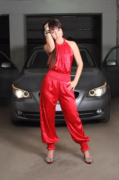 Girl in red near the car — Stock Photo, Image