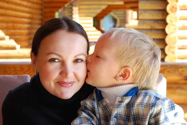 Family portrait - the child kissing mum — Stock Photo, Image