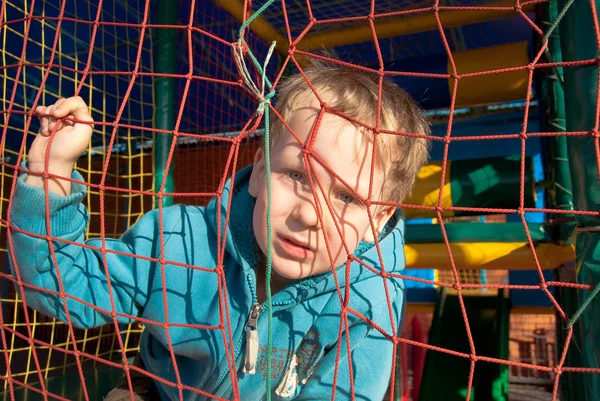 stock image One little boy behind bars