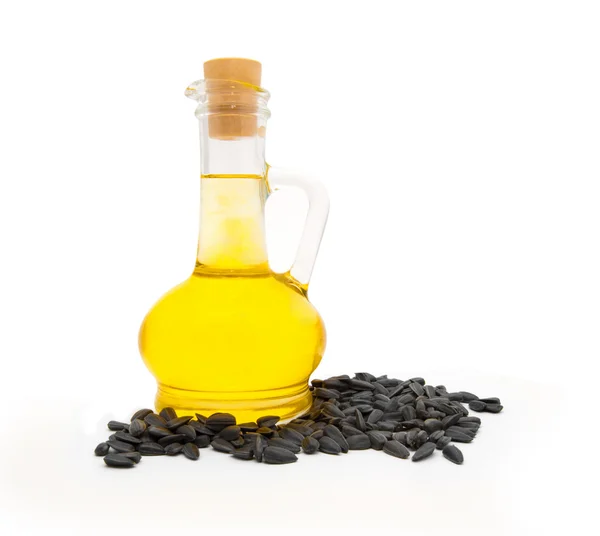 Frasco pequeno com óleo de semente de girassol e sementes de girassol — Fotografia de Stock