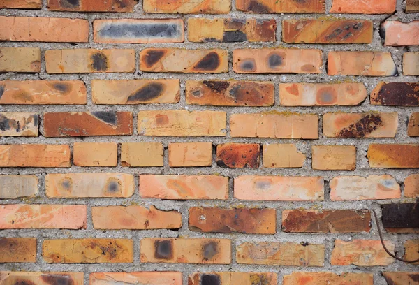 Parede de um tijolo vermelho em um estilo grunge — Fotografia de Stock