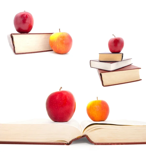 Serie dei libri grossi e le mele su uno sfondo bianco Fotografia Stock
