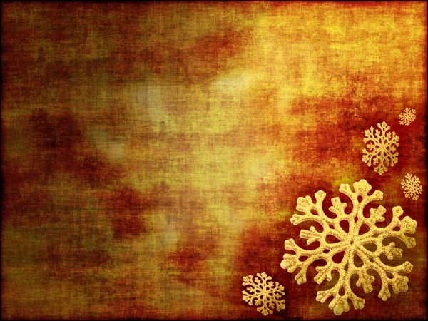 Sfondo nei toni dell'oro decorato con fiocchi di neve — Foto Stock