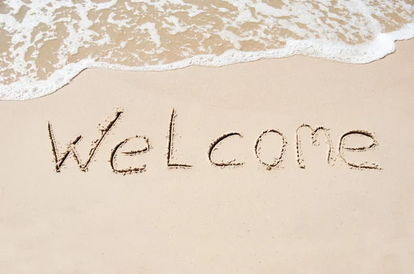 Inscrição bem-vinda em uma areia molhada — Fotografia de Stock