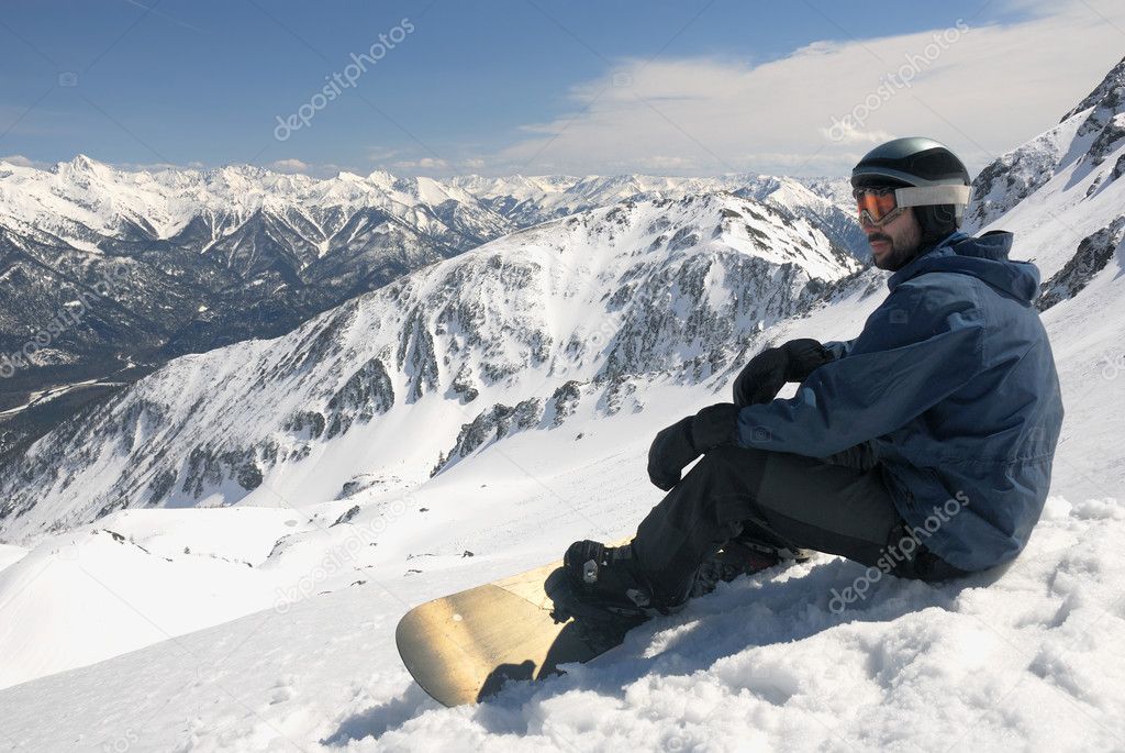 Young snowboarder sitting