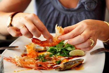 Female hands are scaling prawn