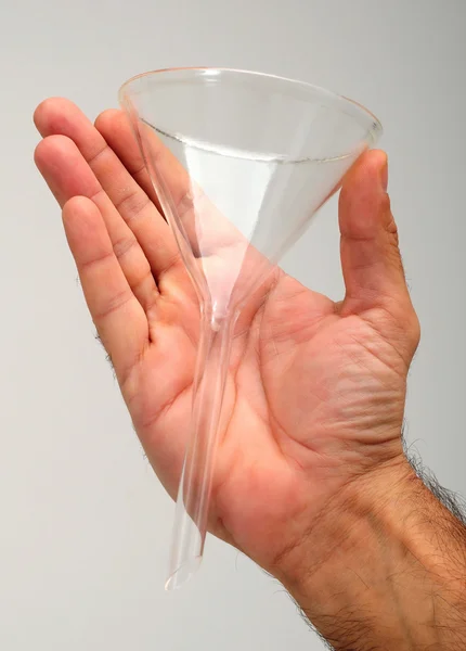 Mão segurando um funil de vidro — Fotografia de Stock