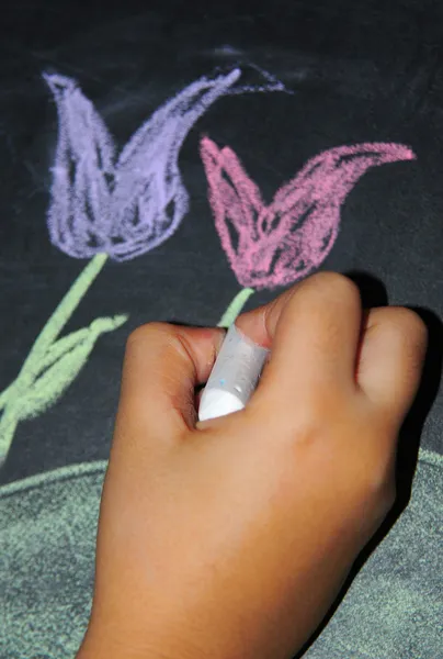 stock image A child's hand drawing a flower