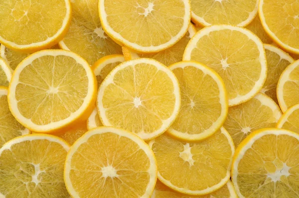 Abstract background with citrus-fruit of lemon slices. Close-up. Studio photography. — Stock Photo, Image