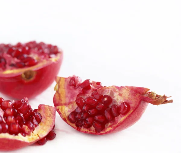 Pomegranates broken-down into three parts on a white background — Stock Photo, Image