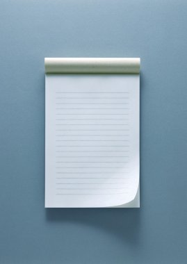 Notepad on the gray-blue background clipart