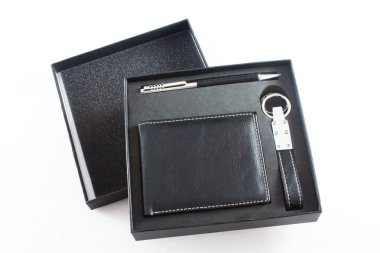 A businessman's leather purse, pen and key ring isolated on whit clipart