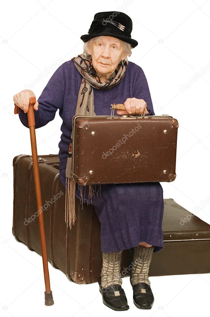 The old lady sits on a suitcase