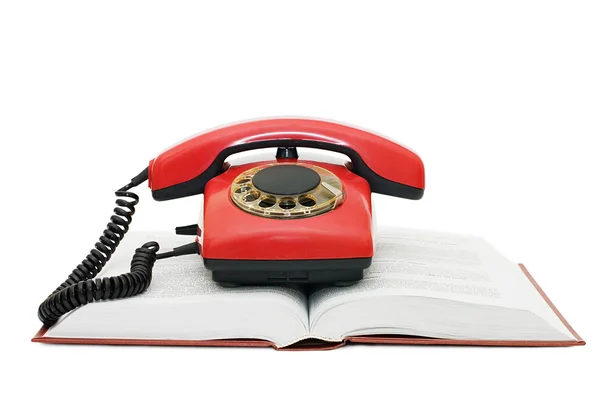 stock image Red phone on the book isolated