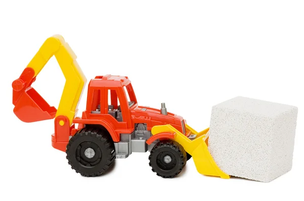 Toy tractor and the block isolated — Stock Photo, Image