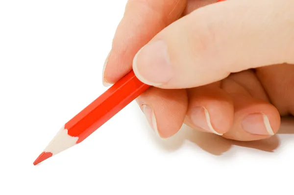 Handen håller en röd penna — Stockfoto