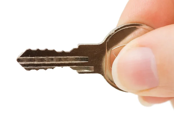 Nyckeln i en hand som isolerad på vit — Stockfoto