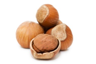 Heap of hazelnuts on white background clipart