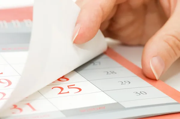 The hand overturns calendar sheet — Stok fotoğraf