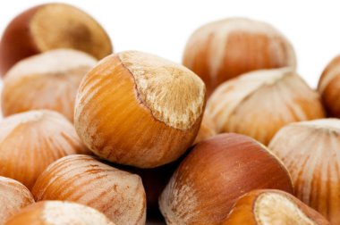 Heap of hazelnuts on white background clipart