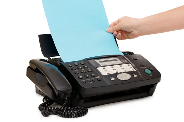 Hand inserts a paper into a fax — Stock Photo, Image