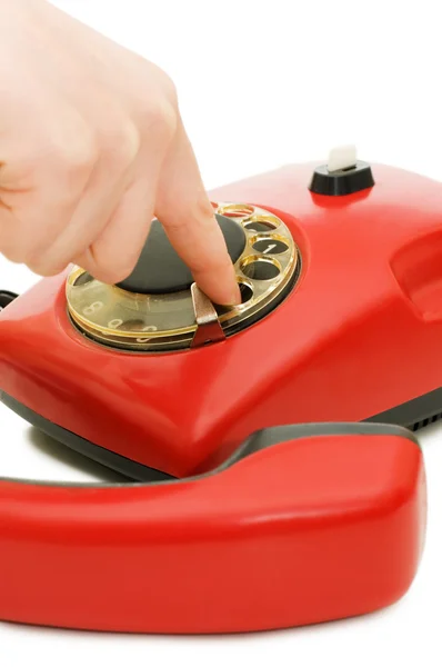 Flickan ringer upp nummer på röd telefon — Stockfoto