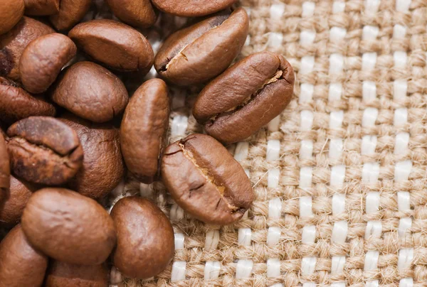 Brown coffee grains on a sacking — Stock Photo, Image