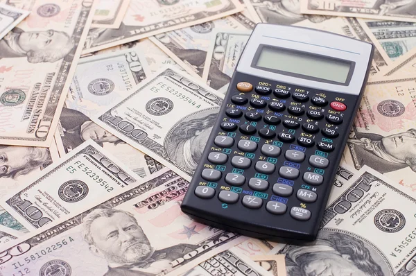 Calculadora sobre fundo do dólar - conceito de negócio — Fotografia de Stock