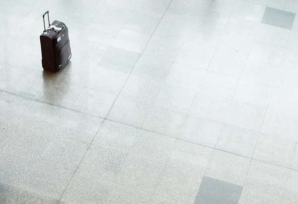 Suitcase with luggage on a floor at the airport — Stock Photo, Image
