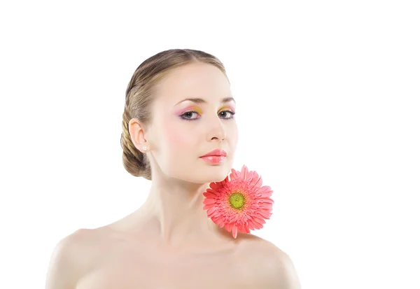 Kvinna med en rosa blomma. Stockbild
