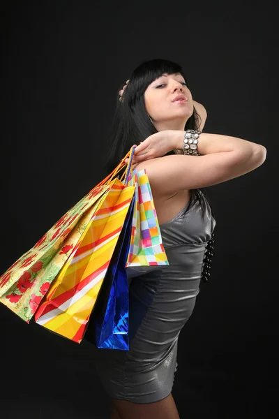 A menina bonita no vestido com sacos de compras — Fotografia de Stock