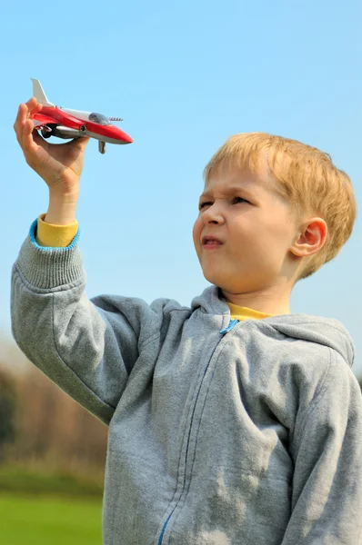 Little boy is playing with toy airplane — Stock Photo, Image