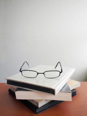 Glasses on books clipart