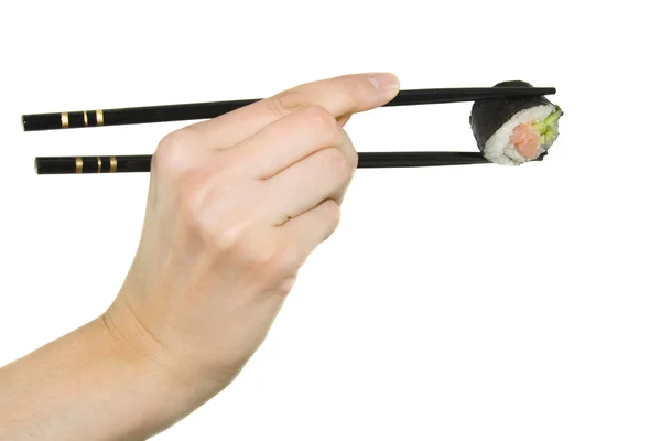 Hand med chopstick tar sushi — Stockfoto